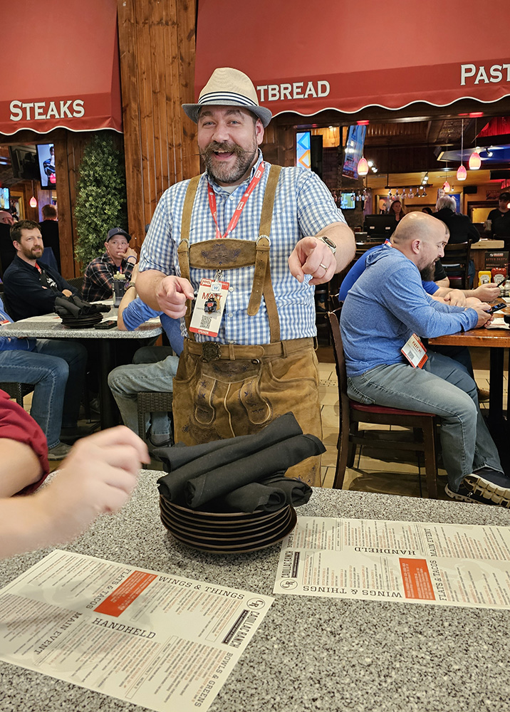 Matt poses for a picture during the WinAdmins dinner while wearing lederhosen.